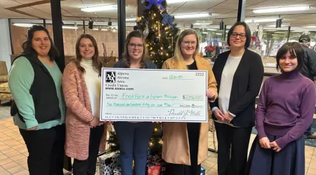 AAACU Team members taking a selfie as they clean up trash in their community